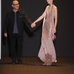 Designer Gilles Mendel walks with a model on the runway at the J. Mendel Fall 2011 fashion show during Mercedes-Benz Fashion Week at the N.Y. State Armory on February 15, 2011 in New York City