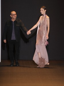 Designer Gilles Mendel walks with a model on the runway at the J. Mendel Fall 2011 fashion show during Mercedes-Benz Fashion Week at the N.Y. State Armory on February 15, 2011 in New York City